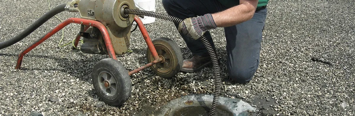 sewer rodding technician actively removing blockages from a sewer line in Overland Park, KS